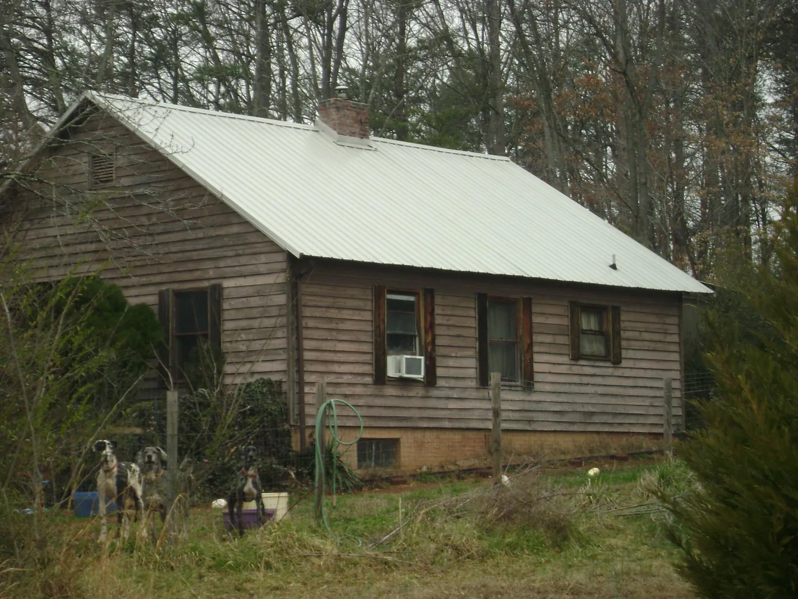White metal roof on an old wood sided farmhouse, from a Metal Roof Installation job in Union